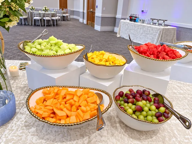Fresh fruit in gold-rimmed serving bowls