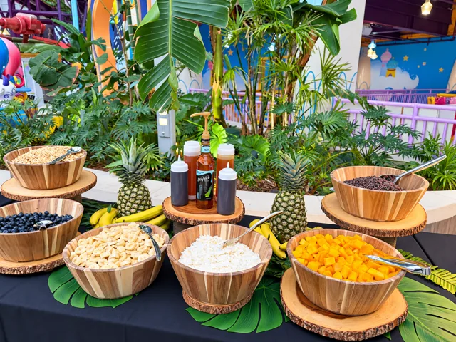 Tropical fruit and topping display in wooden bowls