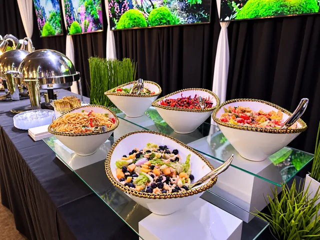 Salad and pasta buffet in gold-rimmed bowls