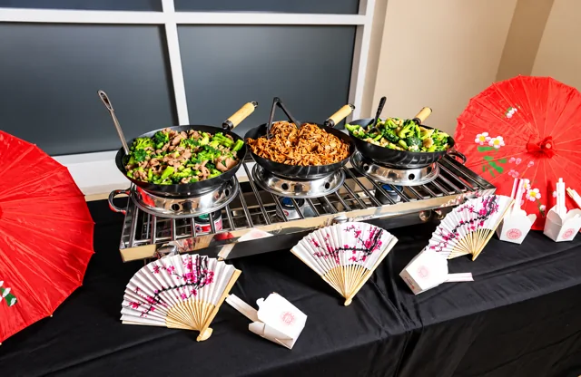 Asian-inspired buffet with fans and red parasols