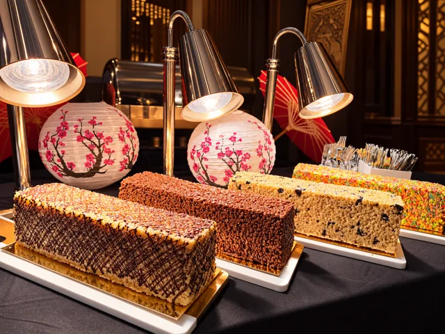Assorted dessert loaves under heat lamps