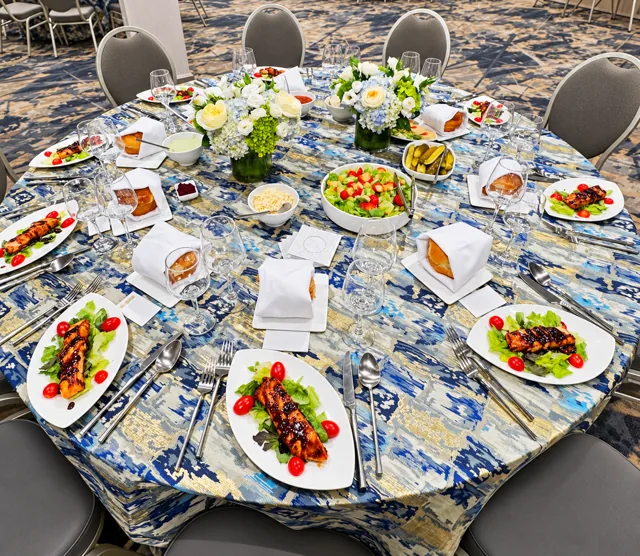 Blue and gold table setting with floral centerpieces