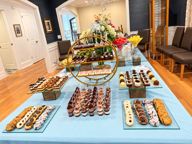 Dessert cups and miniature pastries on blue linens