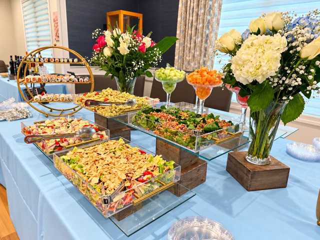 Pasta and salad buffet with floral arrangements