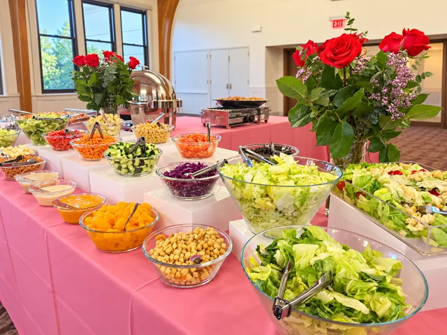 Fresh salad buffet on pink linens