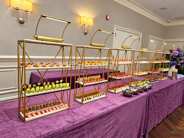 Sushi arranged on gold display racks